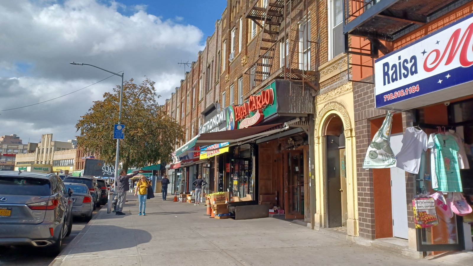 Shops and apartment fronts along Brighton Beach Avenue, photographed in 2022.