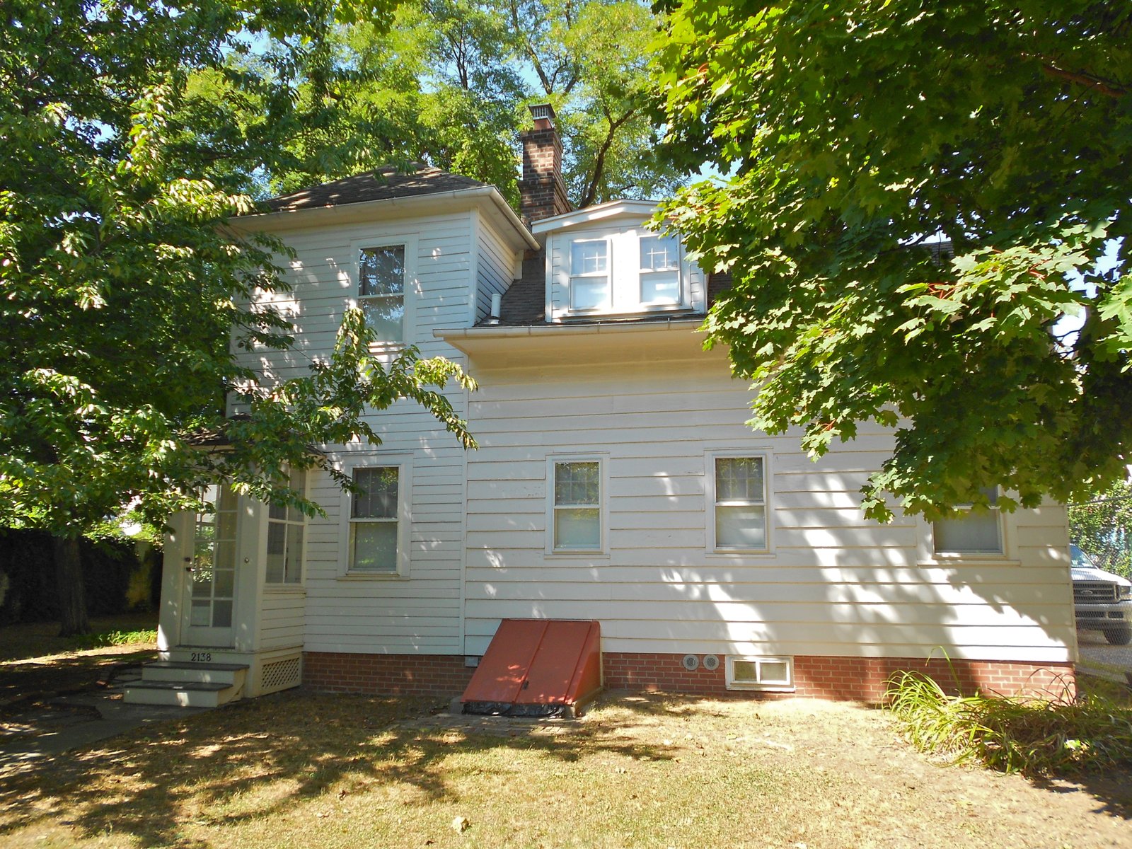 Hubbard House at 2138 McDonald Avenue, photographed in 2013 with trees shading its clapboard exterior.