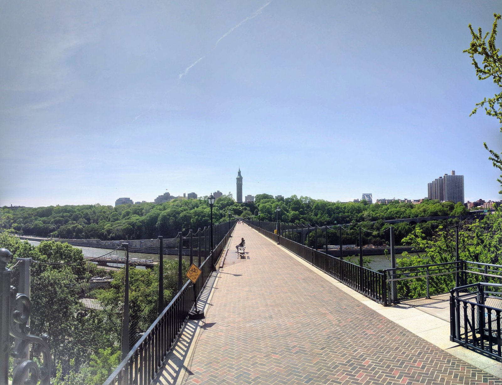 The High Bridge pedestrian deck seen from its Bronx landing, with the water tower across the Harlem River, photographed in 2017.