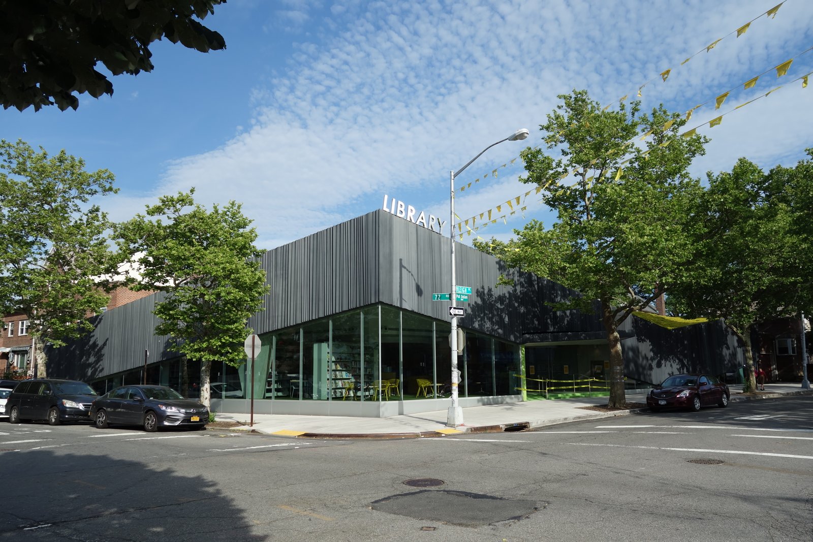 Kew Gardens Hills Library’s folded gray facade and glass corner at Vleigh Place and 72nd Road.