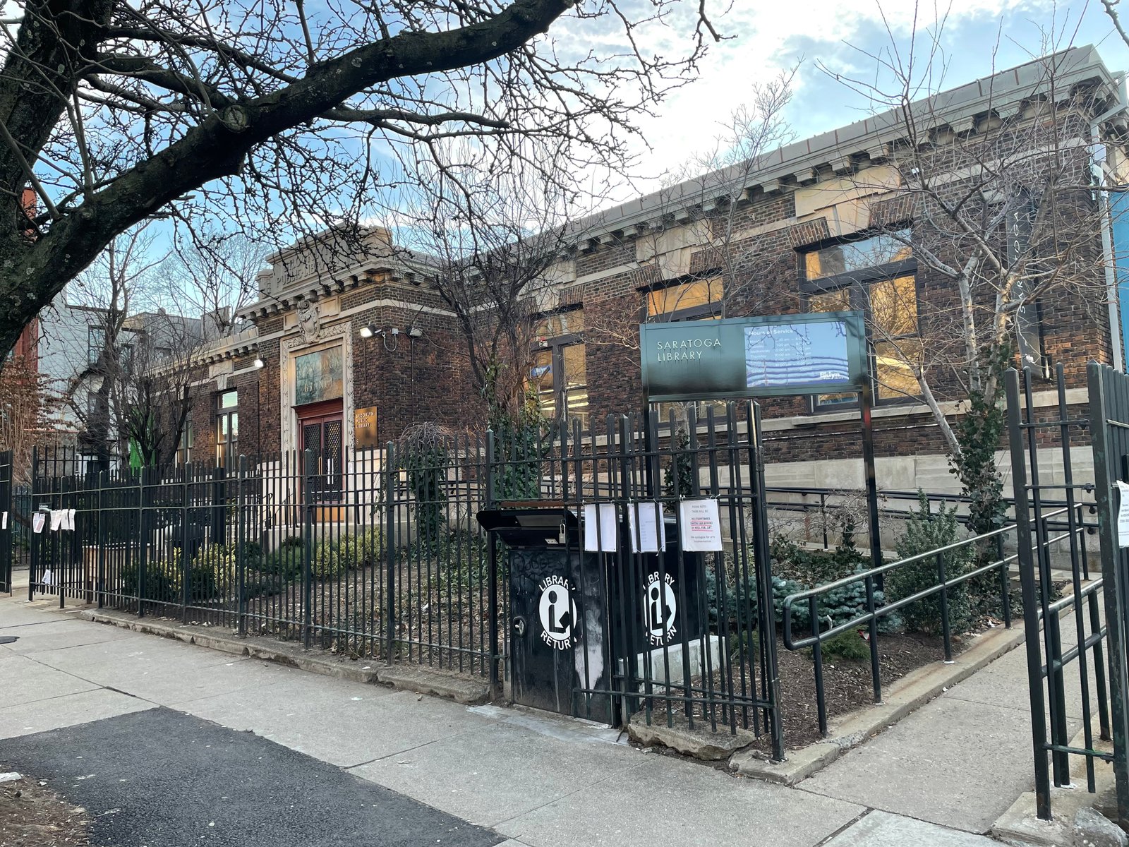Saratoga Library at Thomas S. Boyland Street and Macon Street, with red brick, pale stone trim and an entrance ramp.