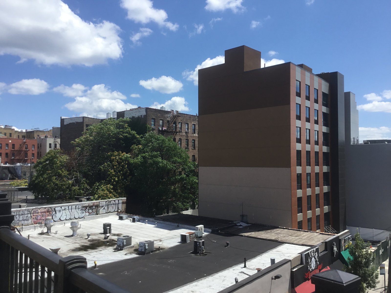 Apartment buildings and shop roofs seen from the Elder Avenue station in Soundview, photographed in 2021.