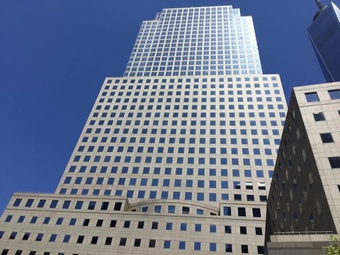 A stepped Brookfield Place tower rises against a blue sky.
