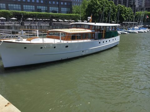 A white boat sits in North Cove marina beside the waterfront.