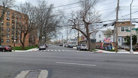 A crosswalk and residential buildings along Whitney Avenue.