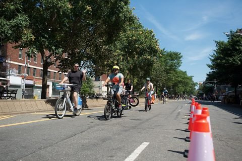 People cycle along Broadway near West 146th Street during Summer Streets.