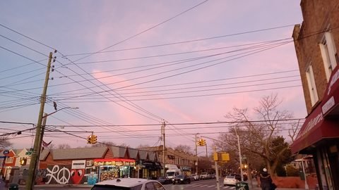 The Avenue S and East 36th Street intersection under a pink evening sky.