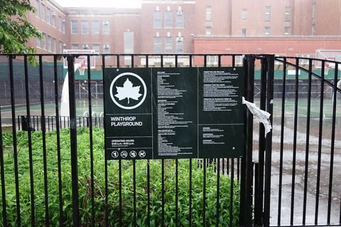 A Parks sign on the fence at the Winthrop Playground entrance.