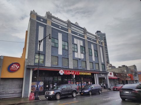 The former theater facade above storefronts on Sheepshead Bay Road.