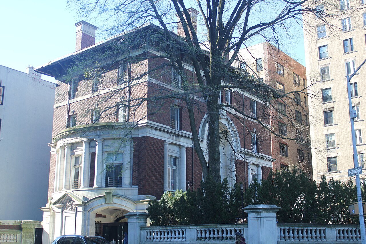 Rice Mansion's red-brick walls and curved marble carriage entrance at West 89th Street in 2024