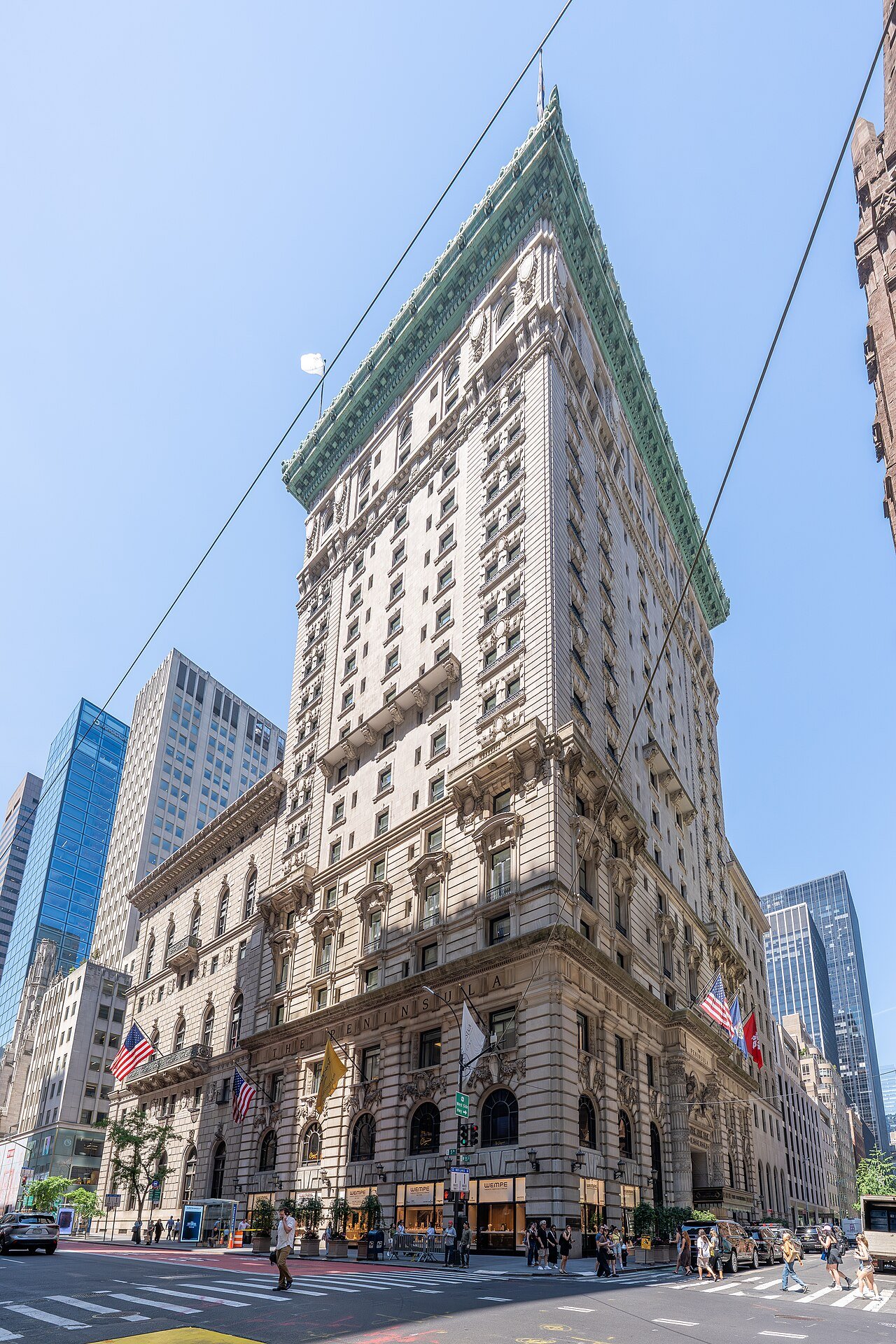 The former Gotham Hotel, now The Peninsula New York, with its carved corner base and upper cornice in 2026