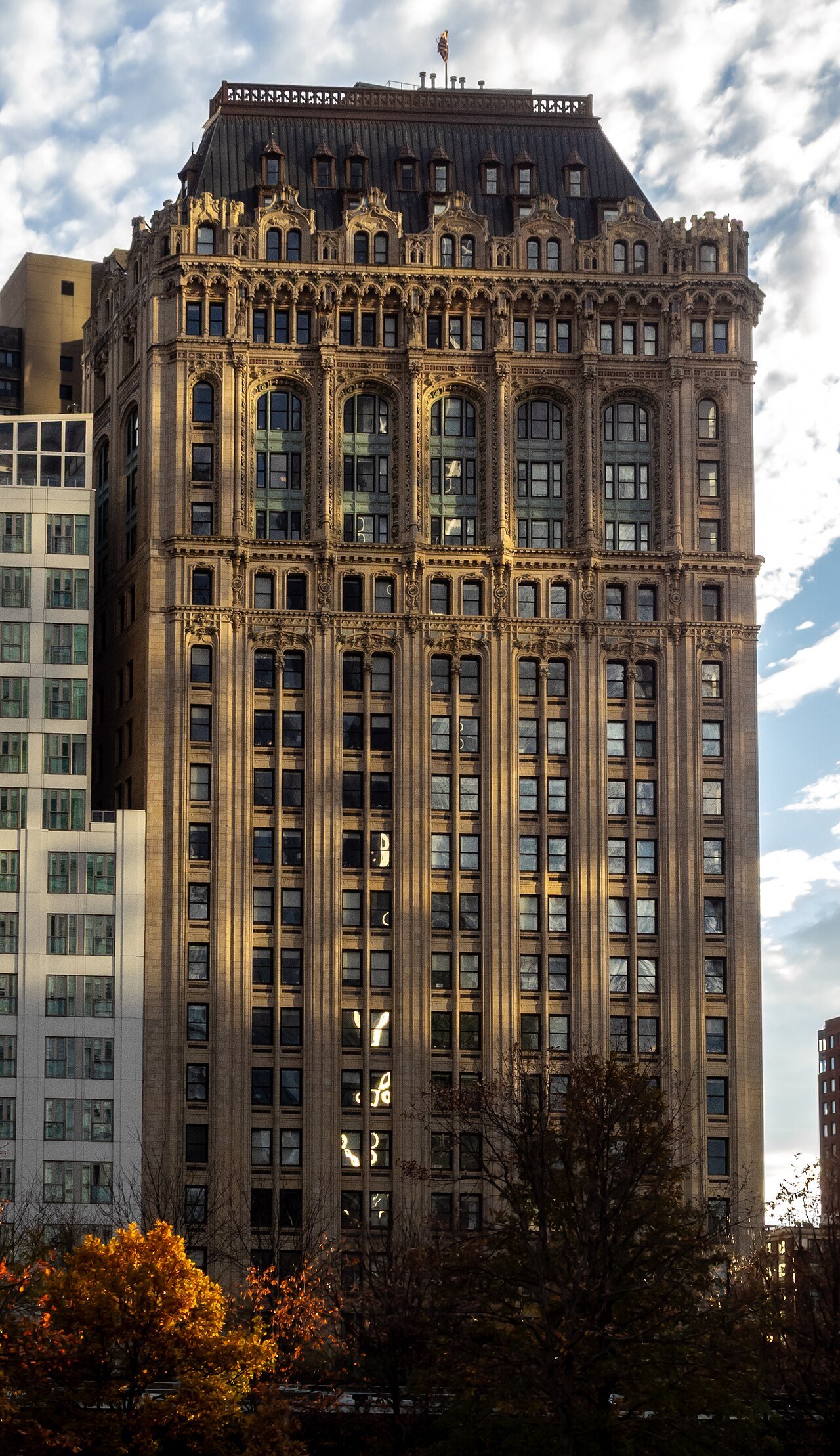 West Street Building's carved upper facade and steep roof in 2025