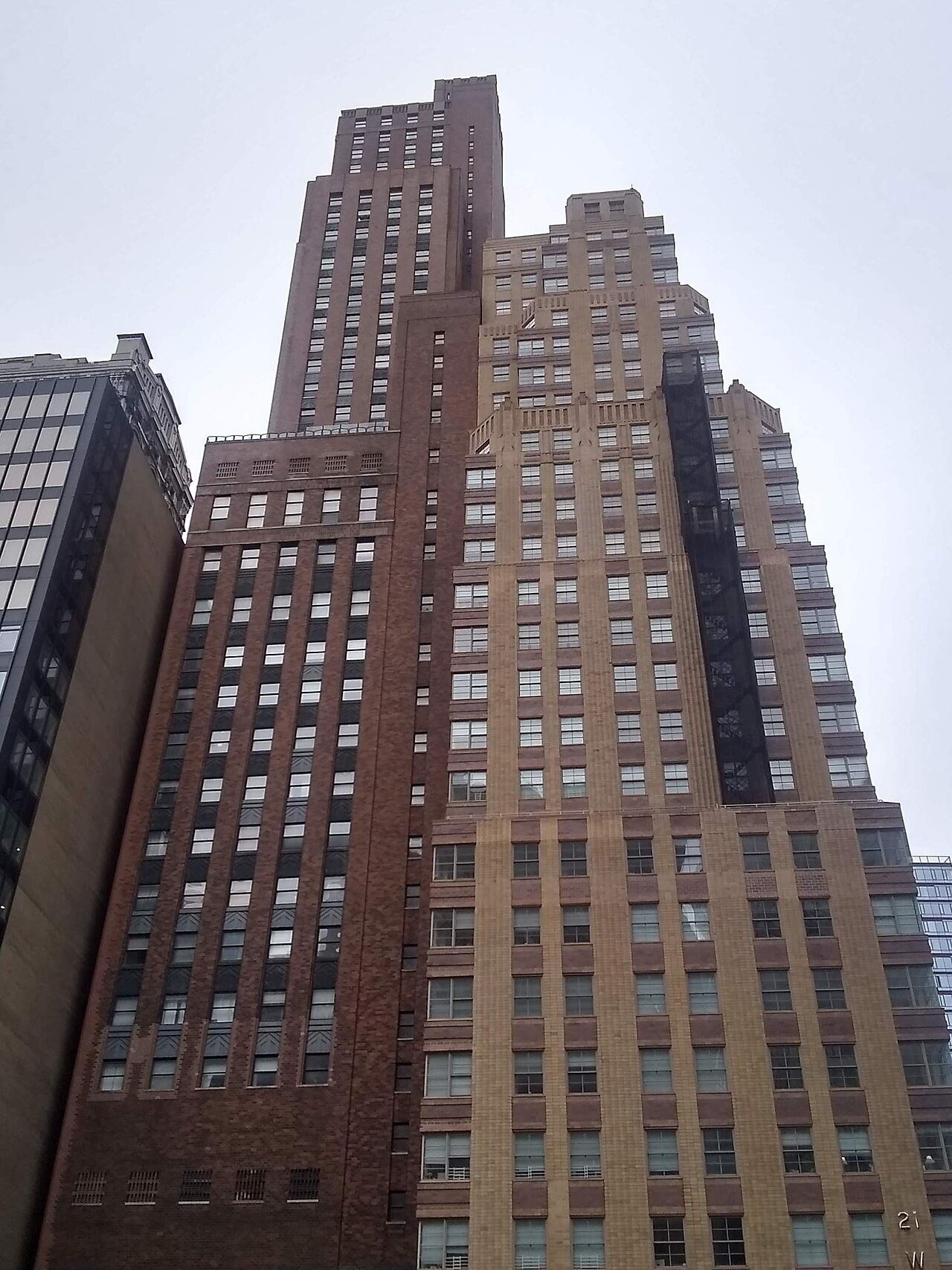 Former Downtown Athletic Club, the larger brick tower at left, beside 21 West Street in 2020