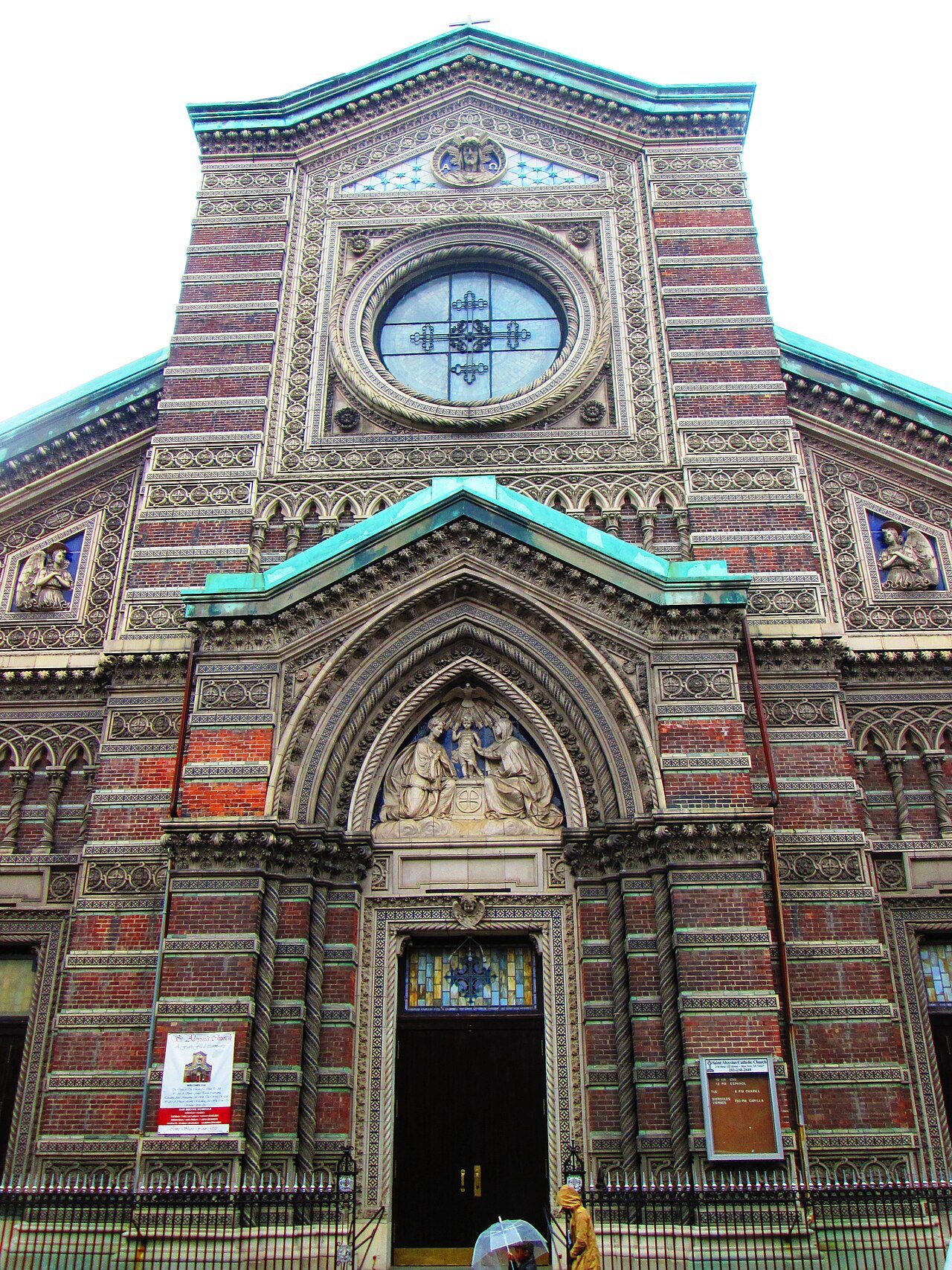 St. Aloysius church with striped ceramics, religious reliefs and its arched entrance in 2014