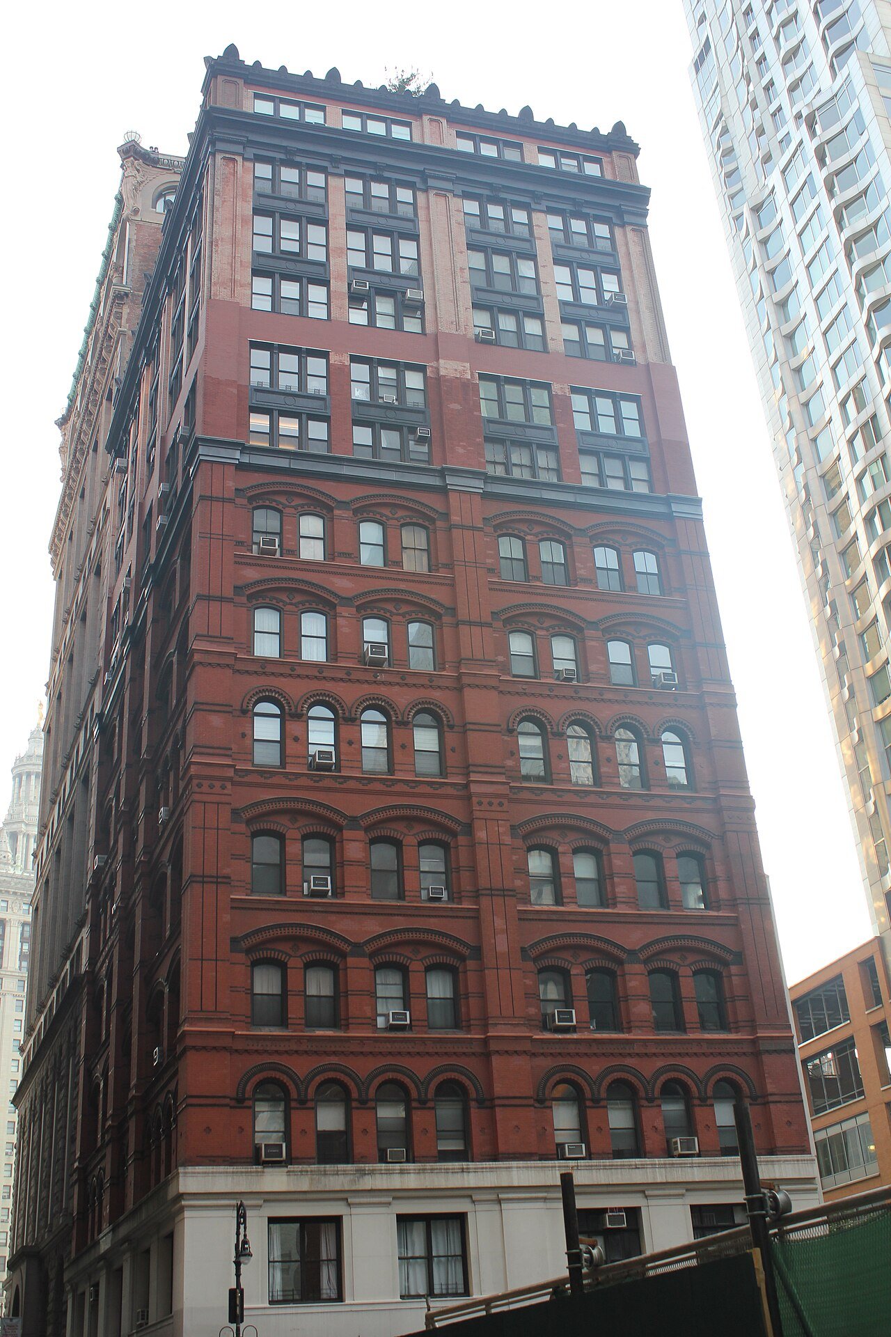 Morse Building's patterned brick facade and later upper addition at Nassau and Beekman Streets in 2021