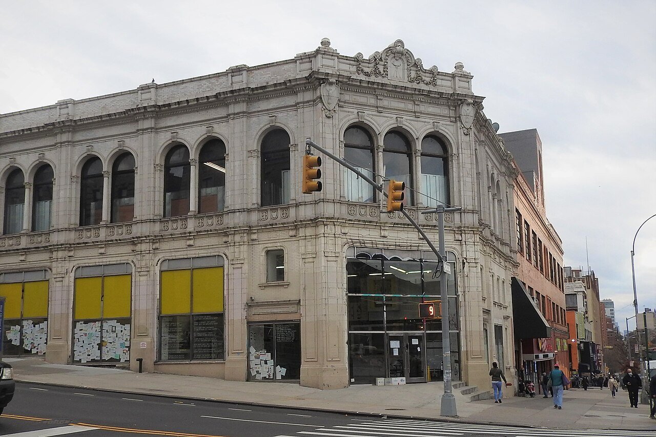 Claremont Theater building with its angled corner and carved movie camera in 2020