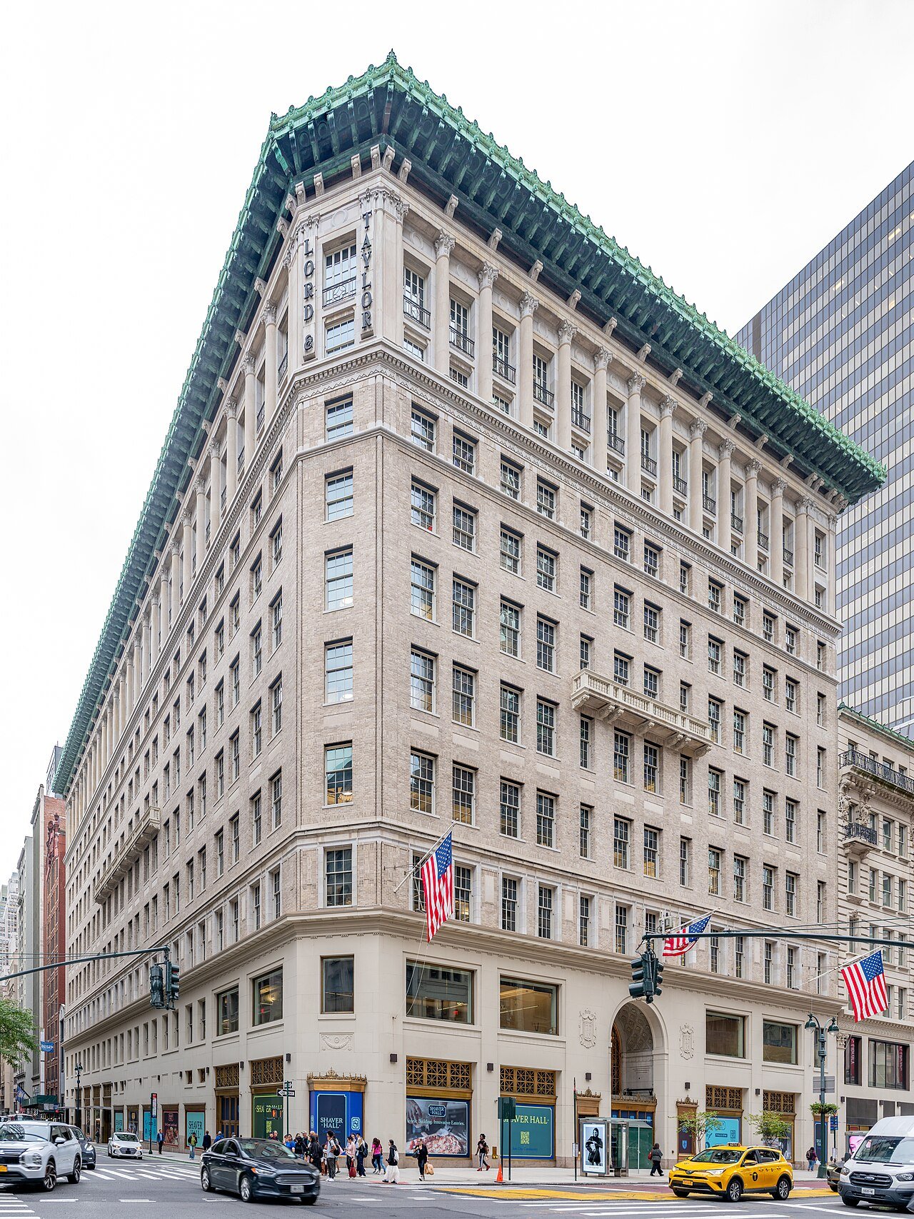 Former Lord & Taylor building with its arched entrance and copper cornice in 2025
