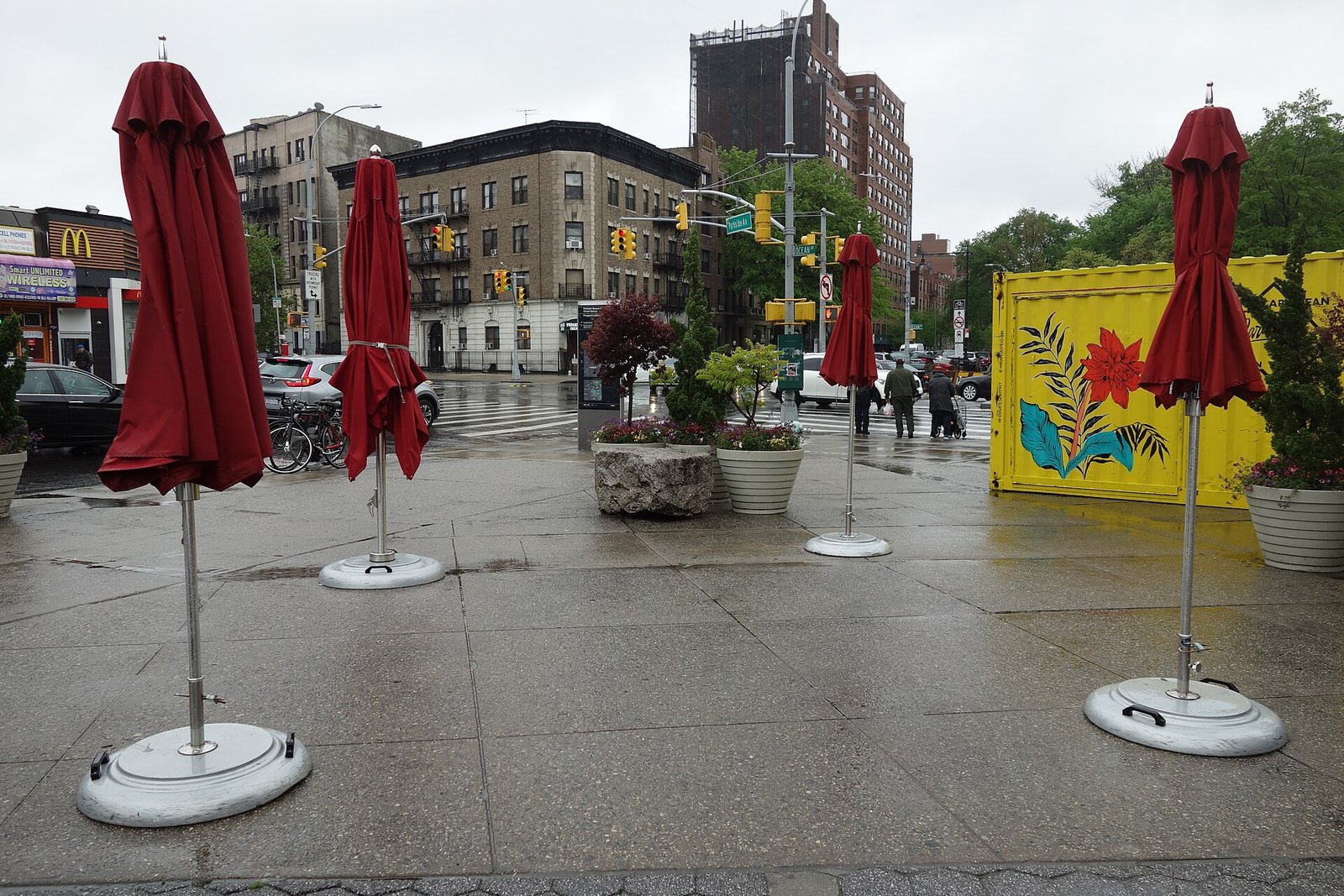 Umbrellas and planters at Parkside Plaza on a rainy day.